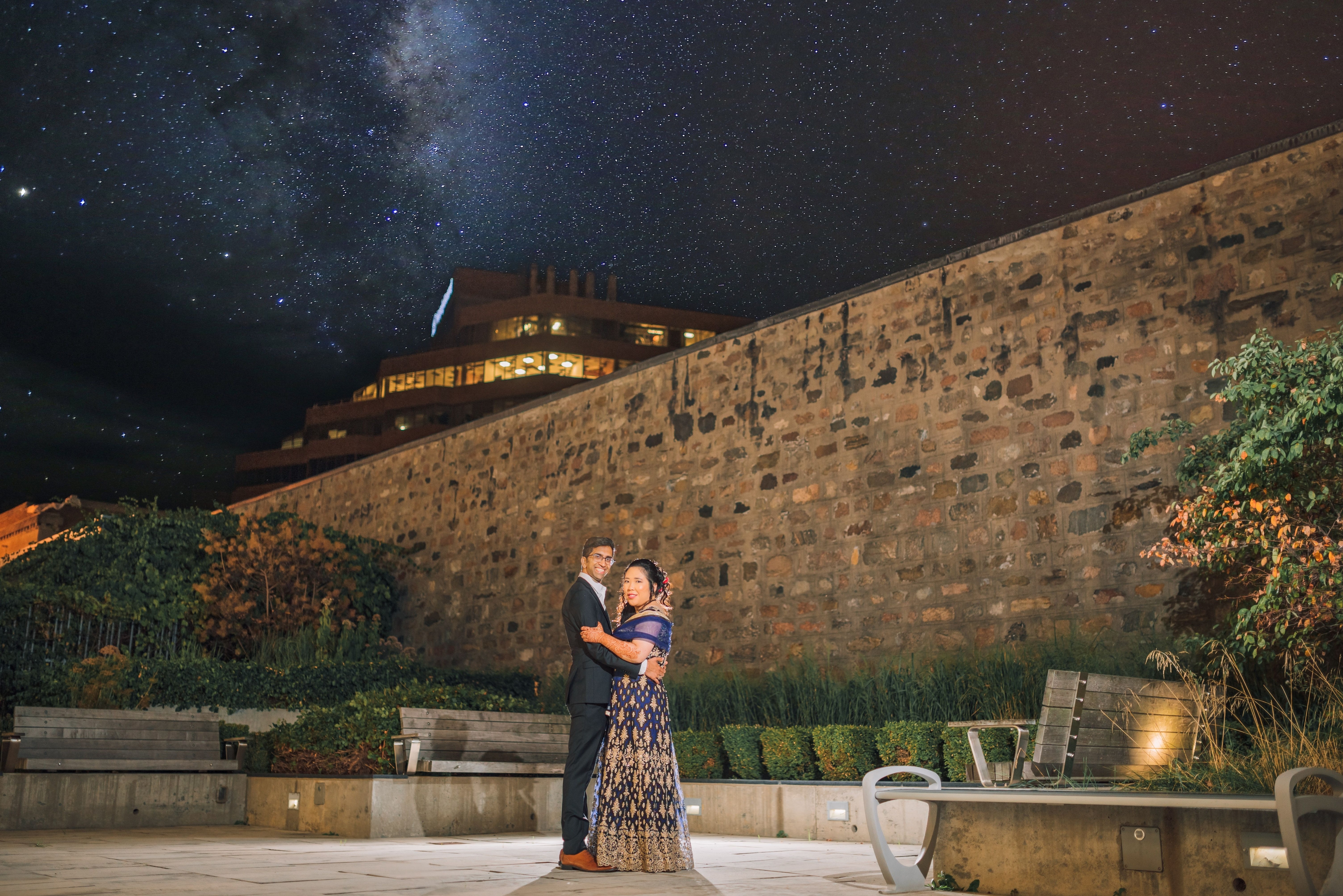 The Wedding Ring, Kitchener Public Library, Peter B Photography, KW wedding photographer, Kitchener wedding venue, Waterloo wedding venue, Cambridge wedding venue, bride and groom kissing in front of old stone wall at nighttime