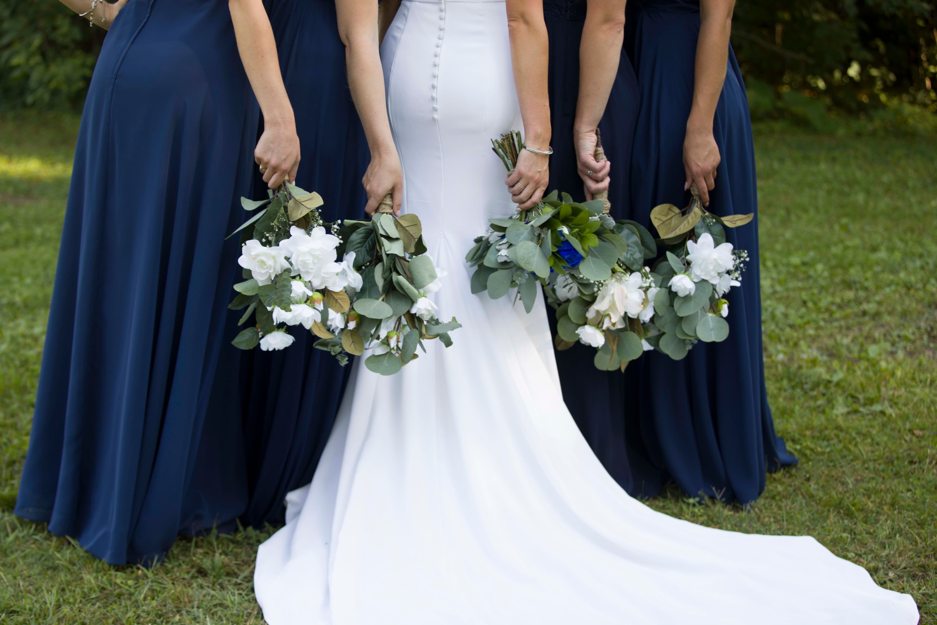 The wedding ring, Heart to heart photography, Thorold wedding photographer, wedding photographer, outdoor wedding, bride and bridesmaids holding flowers behind their backs