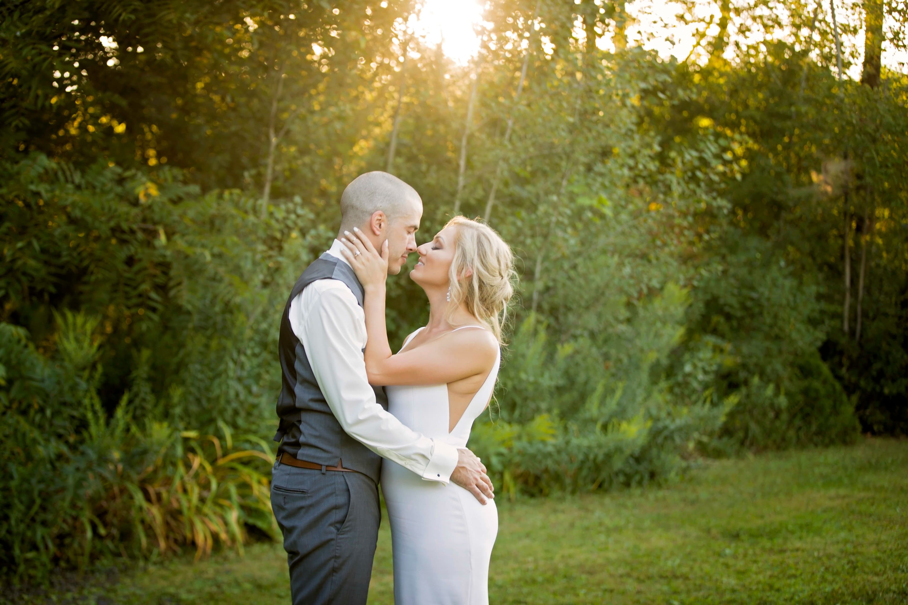 The wedding ring, Heart to heart photography, Thorold wedding photographer, wedding photographer, bride and groom looking at each other at sunset with trees in the background
