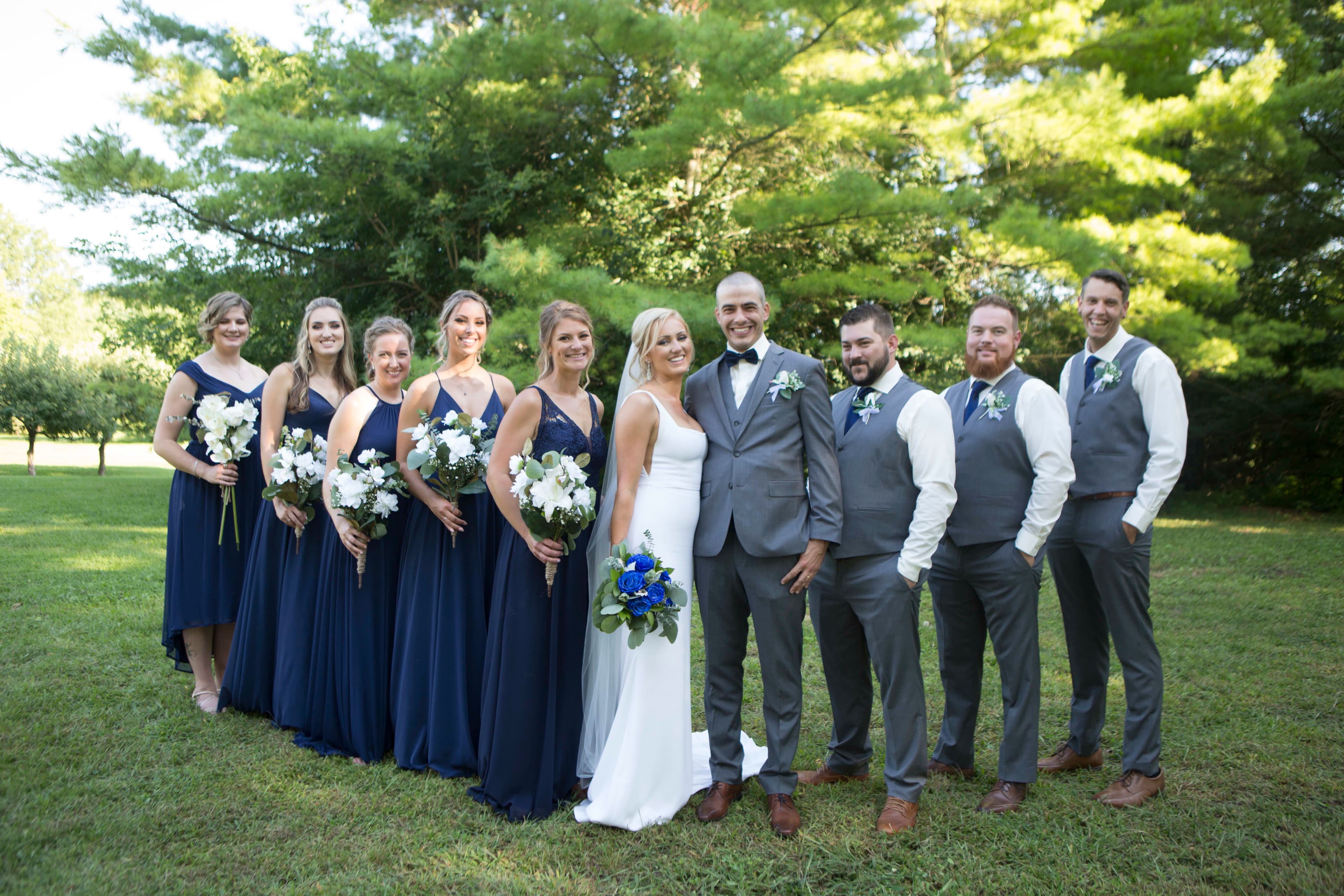 The wedding ring, Heart to heart photography, Thorold wedding photographer, wedding photographer, bride and groom and wedding party  standing in a line looking at the camera with trees in the background