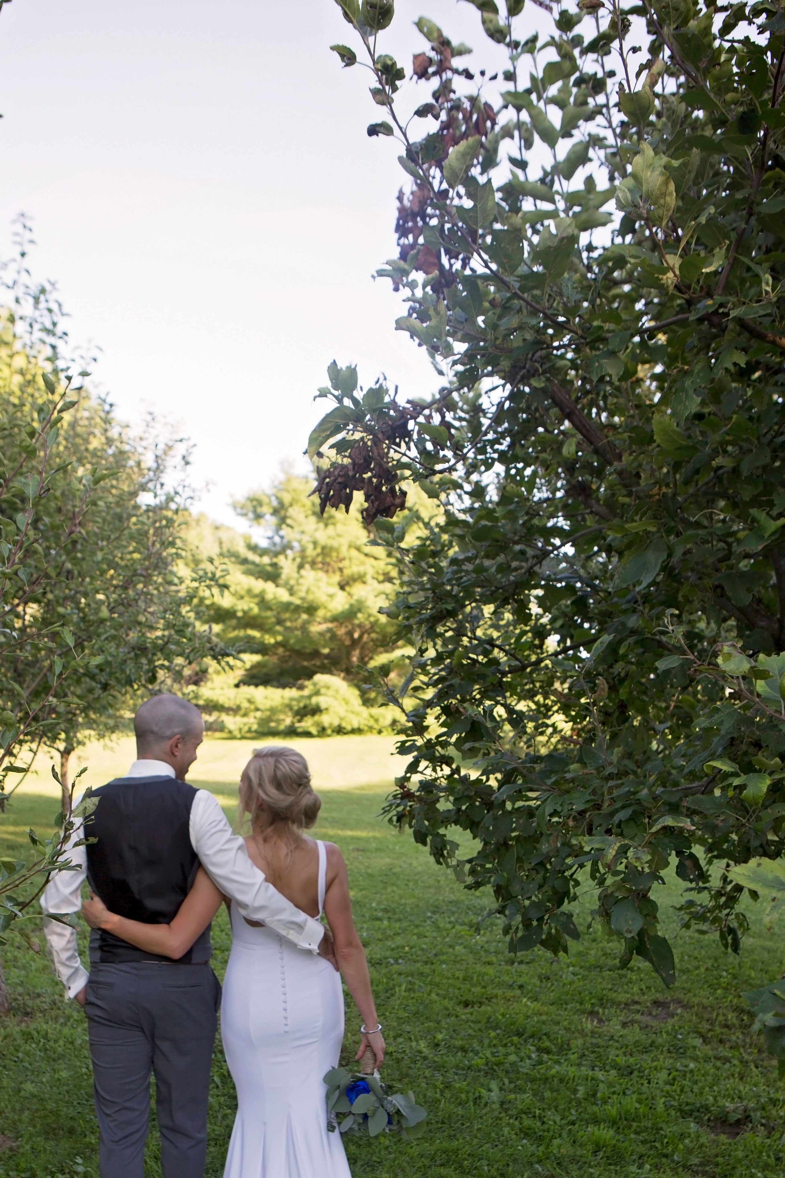 The wedding ring, Heart to heart photography, Thorold wedding photographer, wedding photographer, bride and groom walking away from the camera with their arms around each other