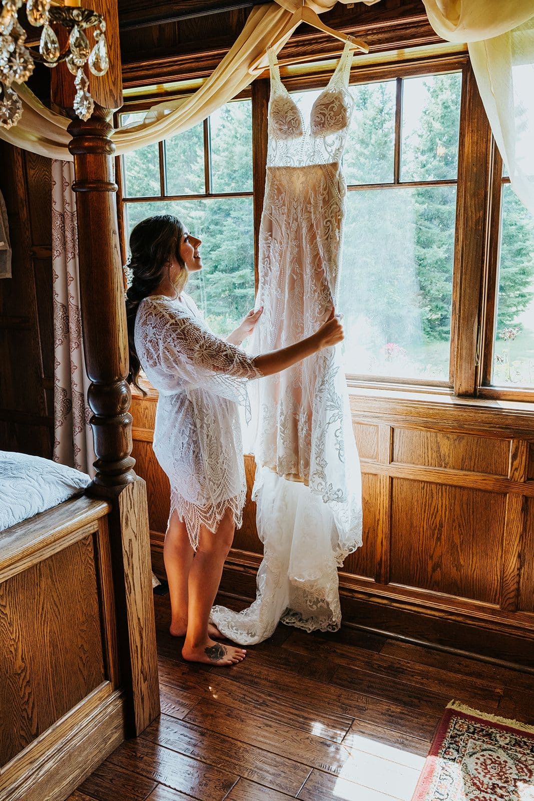 Erin Estates, Wedding Venue, Fedora Media, Cambridge Wedding Photographer, Bride looking at her dress hanging in front of the window