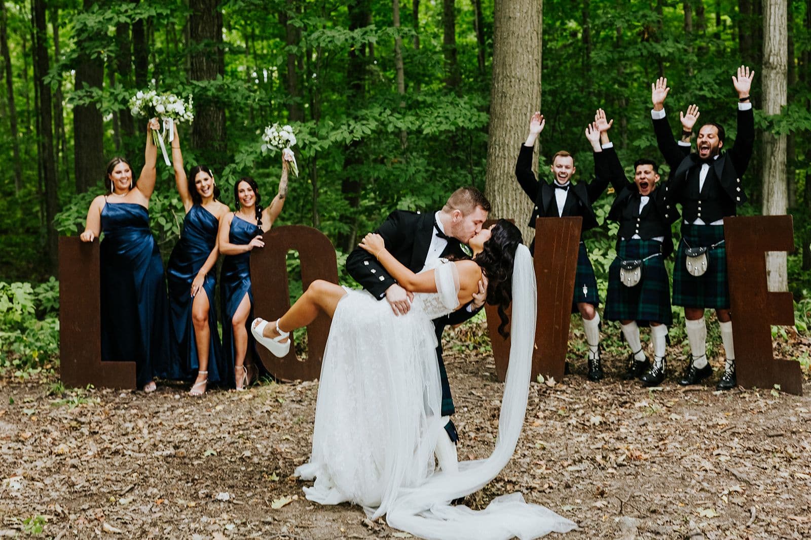 The Wedding Ring, Whistle Bear Golf Club, Wedding Venue, Kitchener Waterloo Wedding Venue, Fedora Media, Kitchener Wedding Photographer, Bride and Groom kissing with their bridal party around them cheering