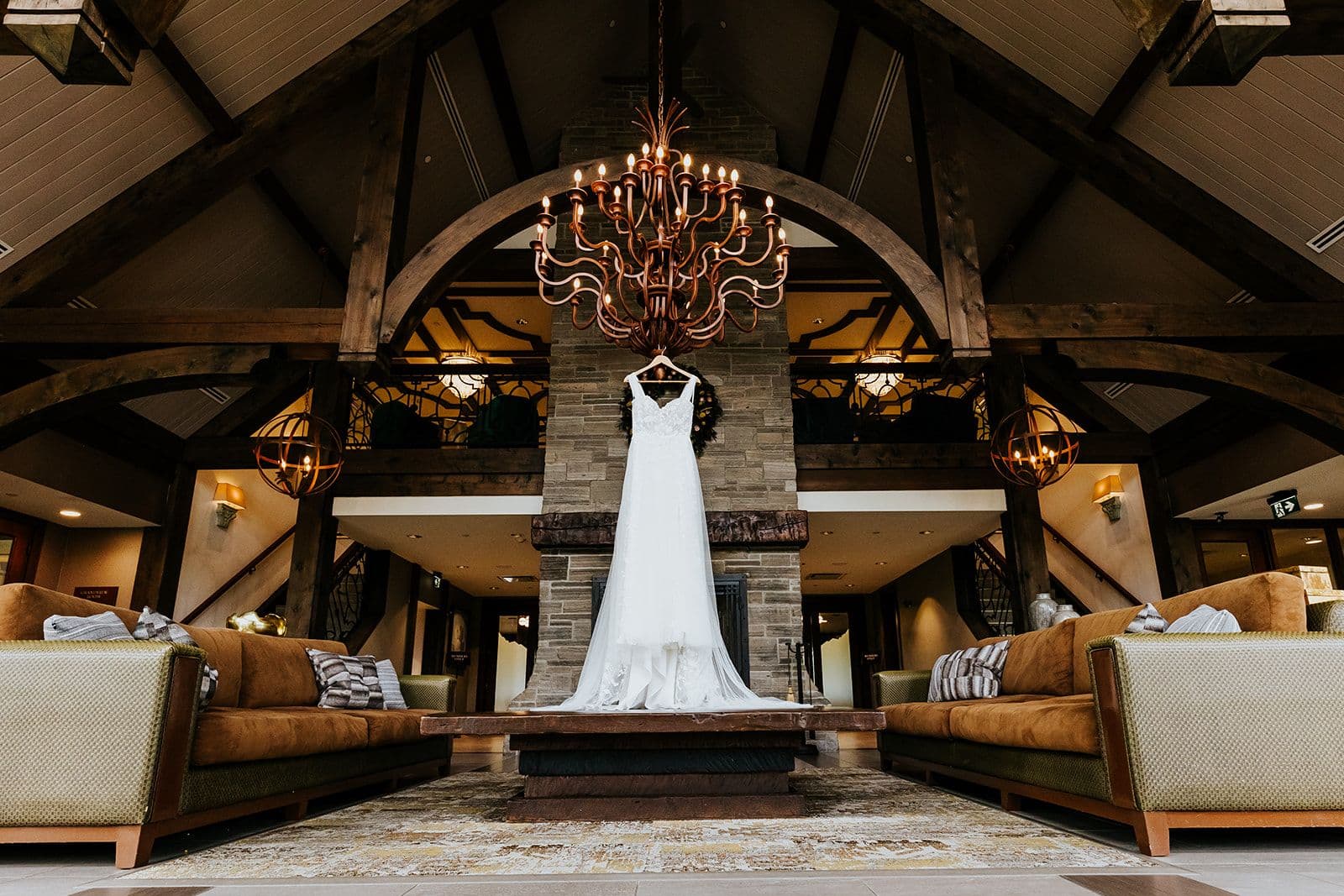 The Wedding Ring, Whistle Bear Golf Club, Wedding Venue, Kitchener Waterloo Wedding Venue, Fedora Media, Kitchener Wedding Photographer, Bride's wedding dress hanging from Chandelier in Whistle bear lobby