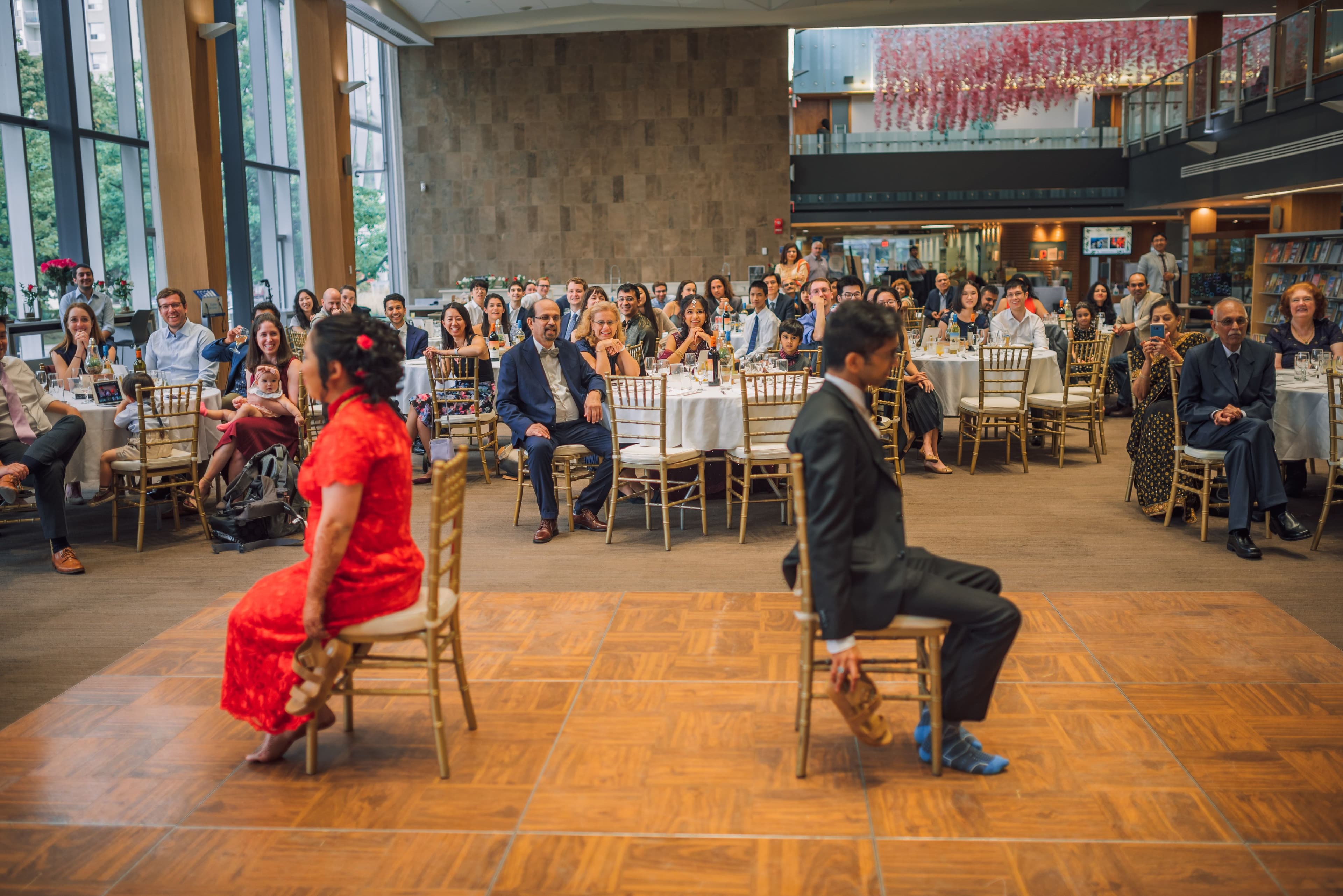 The Wedding Ring, Kitchener Public Library, Peter B Photography, KW wedding photographer, Kitchener wedding venue, Waterloo wedding venue, Cambridge wedding venue, bride and groom sitting in chairs back to back playing a kissing game