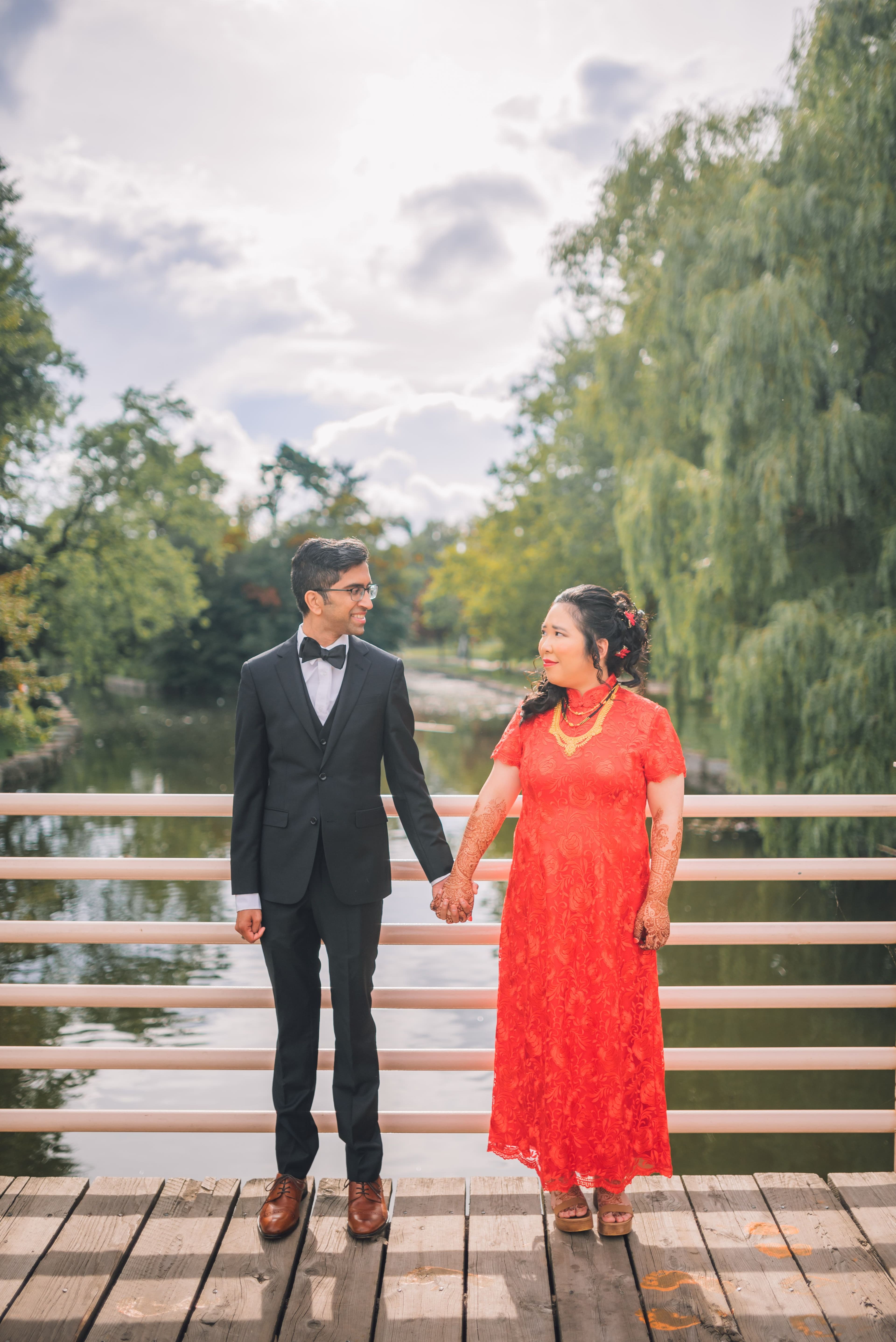 The Wedding Ring, Kitchener Public Library, Peter B Photography, KW wedding photographer, Kitchener wedding venue, Waterloo wedding venue, Cambridge wedding venue, bride and groom holding hands on bridge with the park behind them