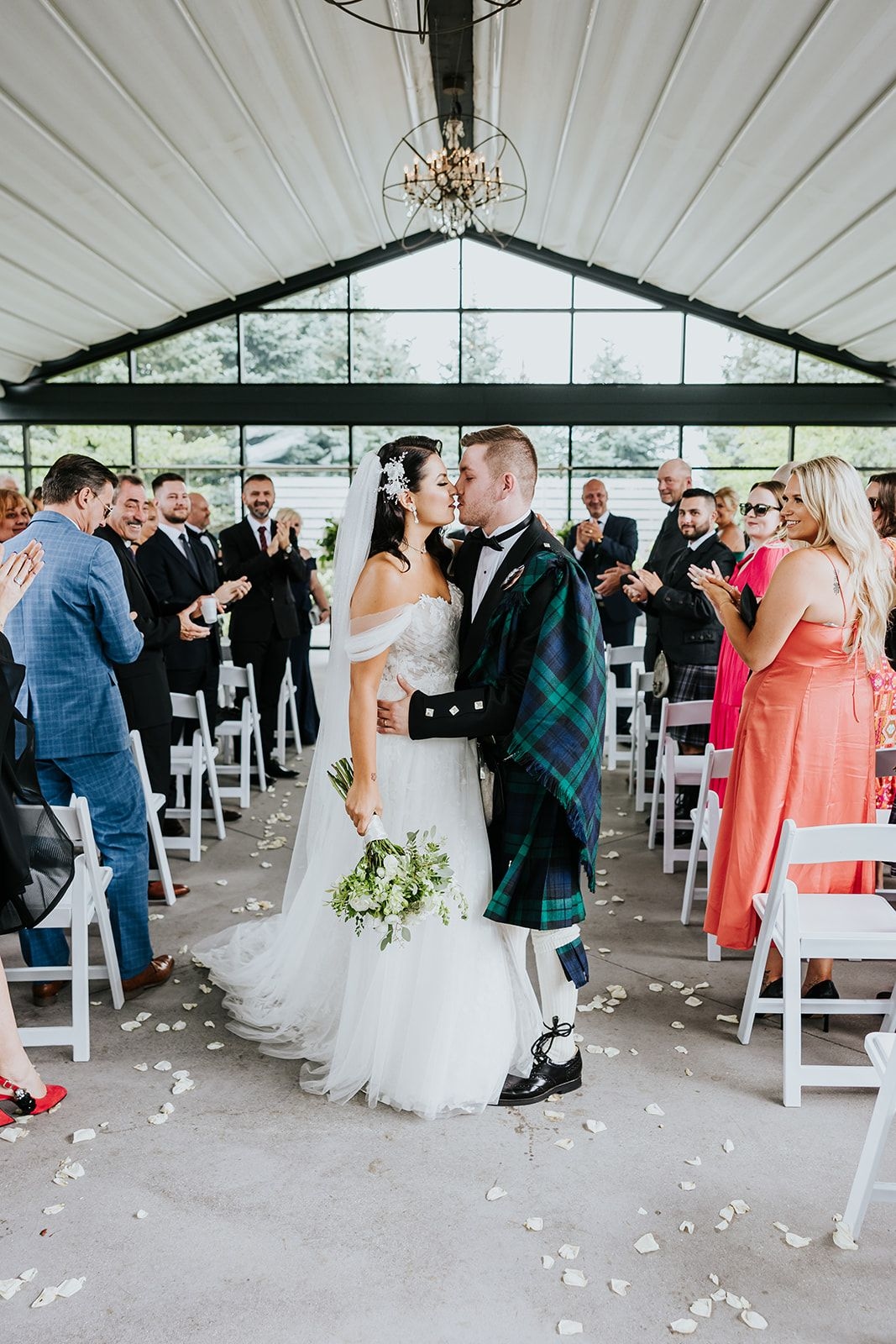 The Wedding Ring, Whistle Bear Golf Club, Wedding Venue, Kitchener Waterloo Wedding Venue, Fedora Media, Kitchener Wedding Photographer, Bride and Groom kissing at the end of the aisle with their guests cheering