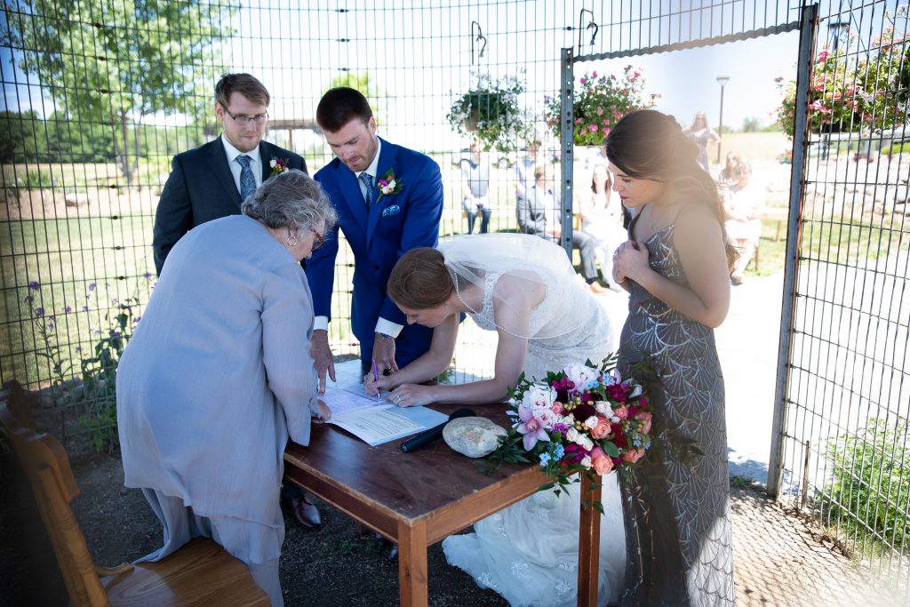 Brian Limoyo photography, bride and groom signing marriage licence